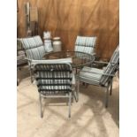 A GLASS TOPPED CIRCULAR TABLE 100CM DIAMETER AND FOUR CHAIRS WITH STRIPED CUSHIONS