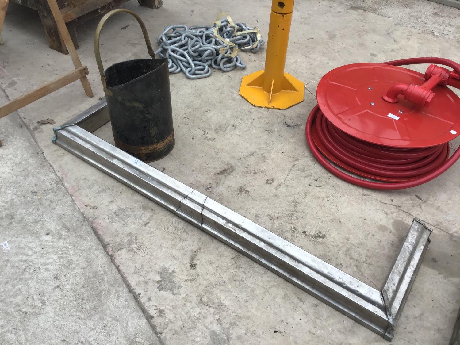 A SILVER COLOURED FIRE SURROUND 134CM X 38CM AND METAL COAL BUCKET (CORROSION TO BASE)