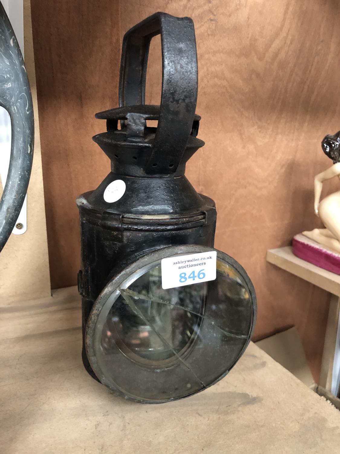 A VINTAGE RAILWAY LANTERN WITH BLACK AND WHITE LIGHT