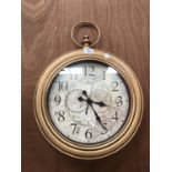 A GOLD COLOURED FRAMED WALL CLOCK