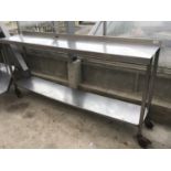 A STAINLESS STEEL TWO SHELF UNIT ON WHEELS 193CM X 41CM X 96CM HIGH