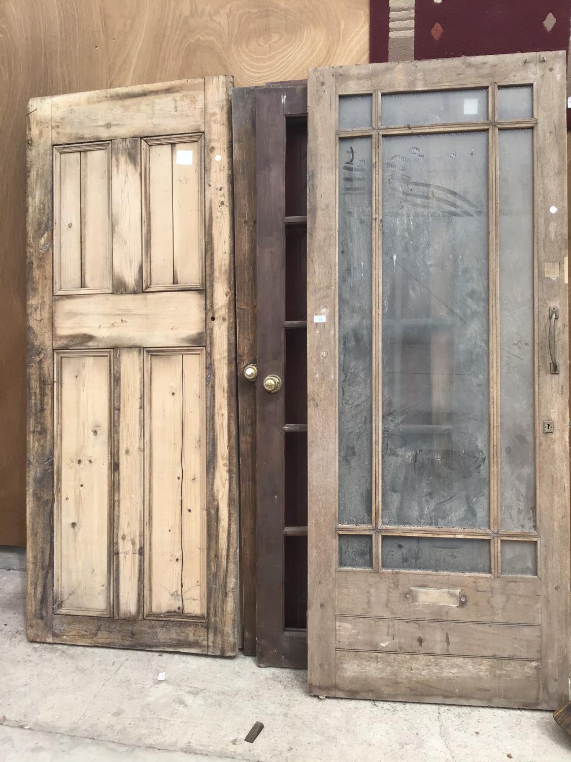 SEVEN VARIOUS VINTAGE DOORS TO INCLUDE THREE PINE PANELED 202CM X 80.5CM, 197CM X 80CM X 195 X 75.5,