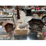 TWO BLACK FOREST WOODEN CLOCKS AND FURTHER BOX AND CONTENTS