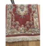 A DECORATIVE PATTERNED RUG WITH FRINGING 175CM X90CM