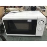 A WHITE MICROWAVE IN WORKING ORDER