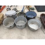 SEVEN VARIOUS STAINLESS STEEL, CAST IRON AND BRASS PANS