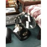 A SMALL DESK MAGNIFYING GLASS ON STAND