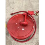 AN AS NEW HEAVY DUTY RED FIRE HOSE PIPE ON A REEL WITH FITMENTS
