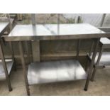 A STAINLESS STEEL TABLE WITH LOWER SHELF 110CM X 65CM X 97CM HIGH