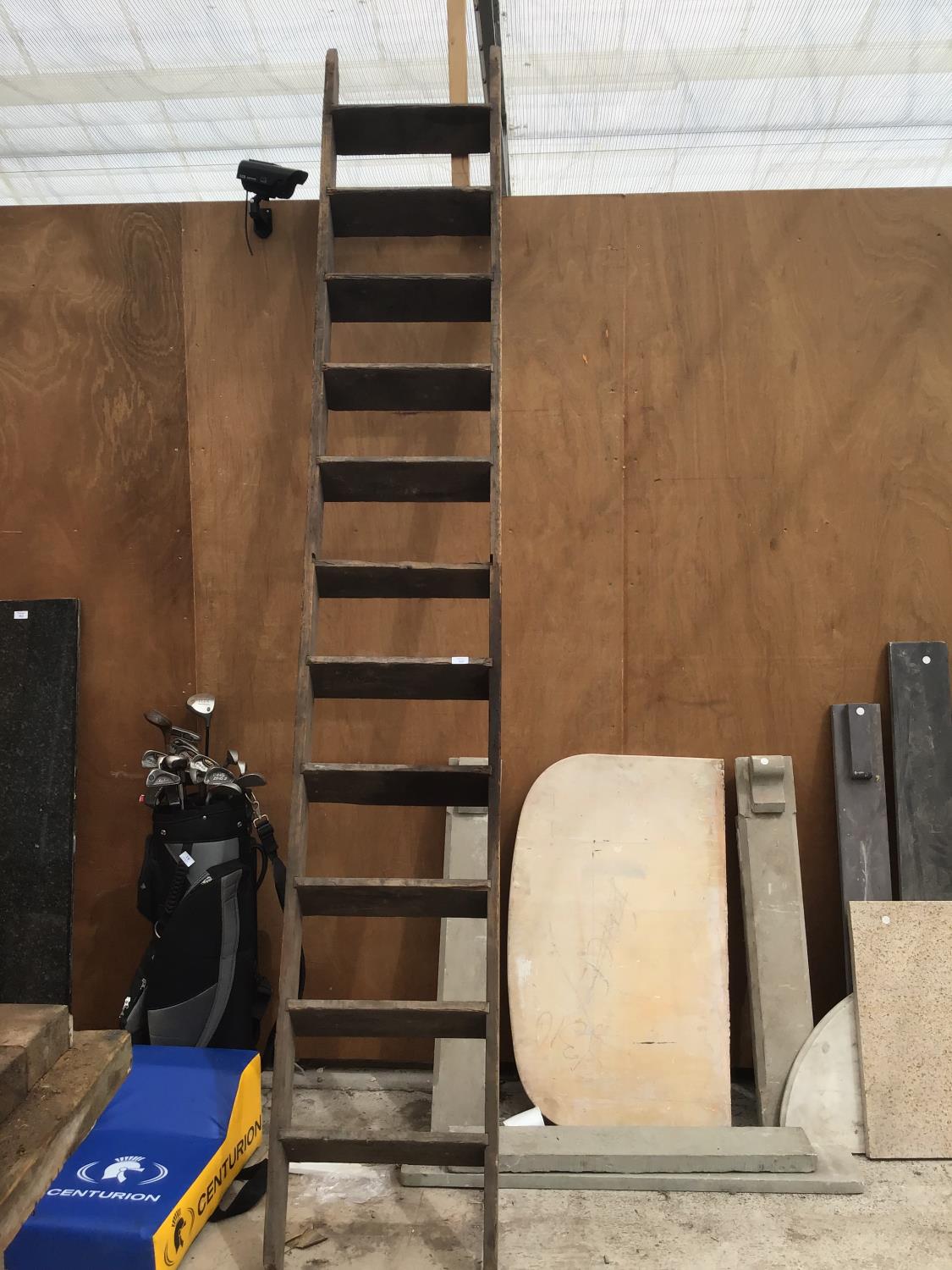 A VINTAGE ELEVEN RUNG WOODEN LADDER