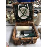 A PICNIC BASKET SET TO INCLUDE CUPS, PLATES ETC