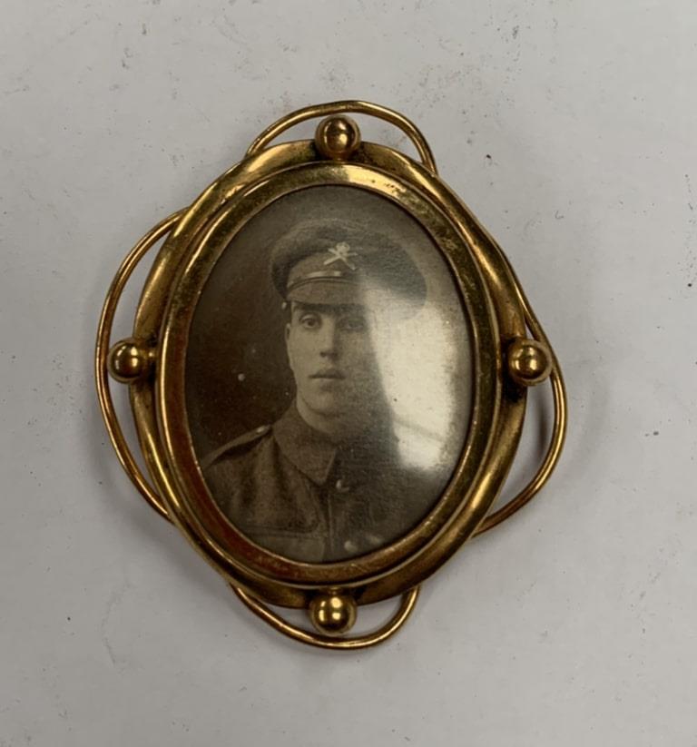 A DOUBLE SIDED PINCH BACK WORLD WAR ONE PHOTO BROOCH