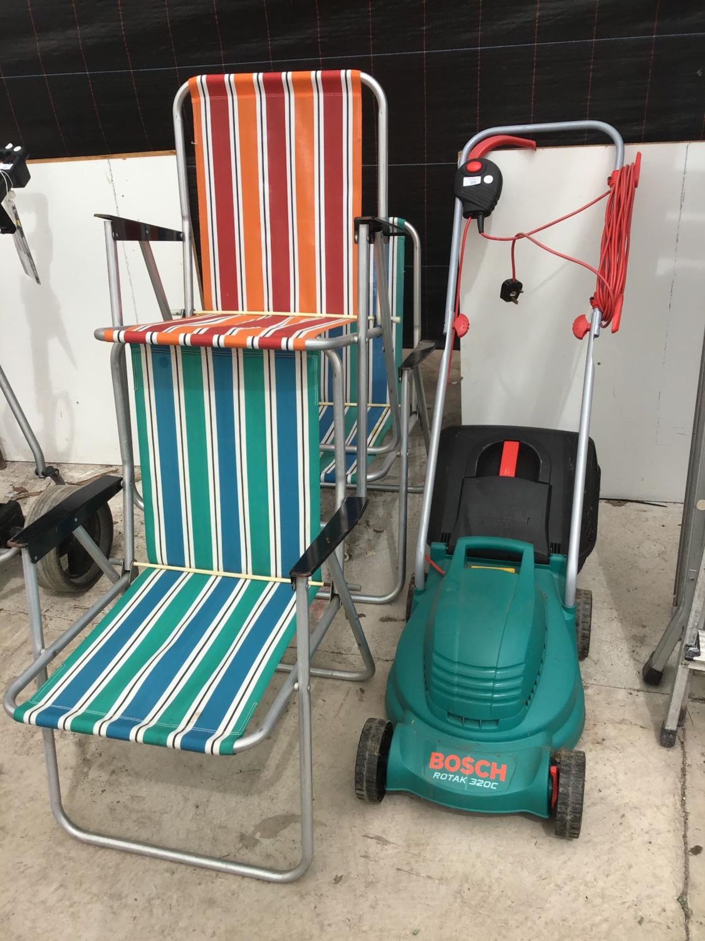 A BOSCH ROTAK 360 ELECTRIC LAWN MOWER IN WORKING ORDER AND THREE VINTAGE STRIPED FOLDING DECK CHAIRS