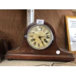 A WOODEN MANTLE CLOCK