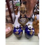 A DECORATIVE CERAMIC MODERN CLOCK GARNITURE SET