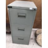 A THREE DRAWER METAL FILING CABINET