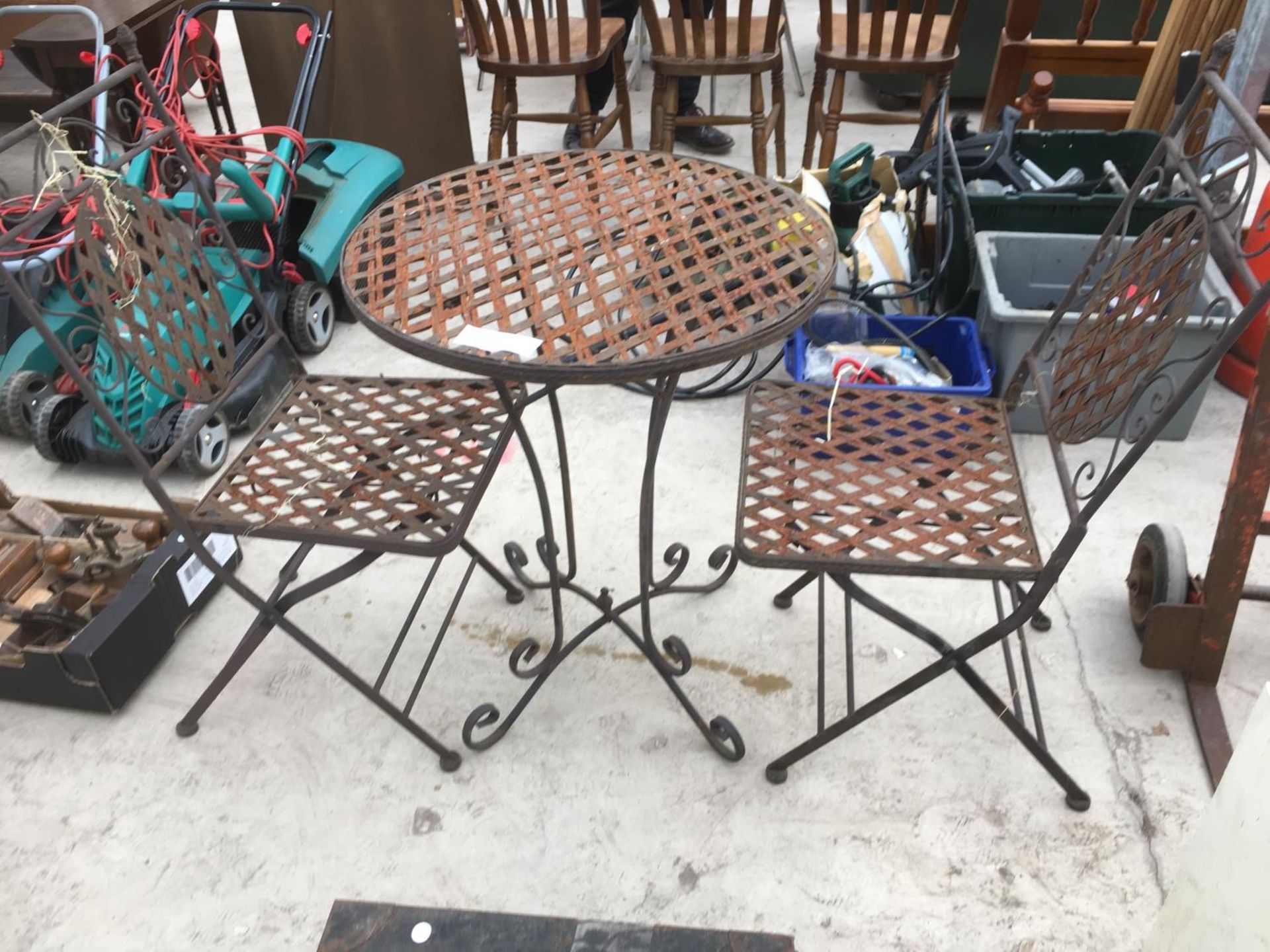 A BISTRO STYLE TABLE AND TWO CHAIRS