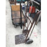 A VINTAGE SACK TRUCK AND A FOUR WHEELED TROLLEY IN NEED OF REPAIR