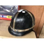 A VINTAGE METAL MOTORCYCLE HELMET