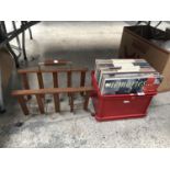 A COLLECTION OF RECORDS AND A WOODEN MAGAZINE RACK