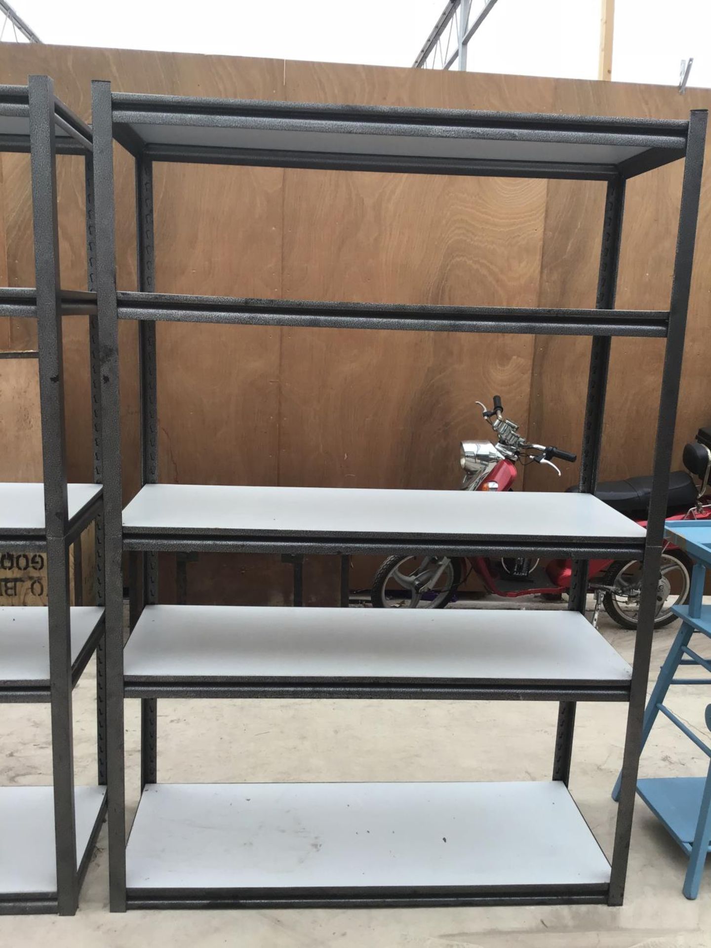 A HEAVY METAL CASE FIVE SHELF SHELVING UNIT