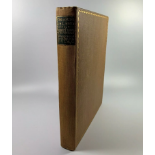 A 1927 1ST EDITION TREASURE ISLAND BOOK WITH BROWN CLOTH BINDING AND GOLD LEAF BORDER DESIGN AND A