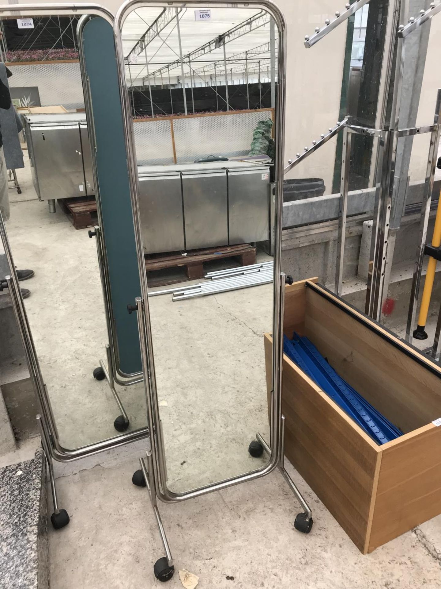 A FULL LENGTH SHOP MIRROR ON CASTERS