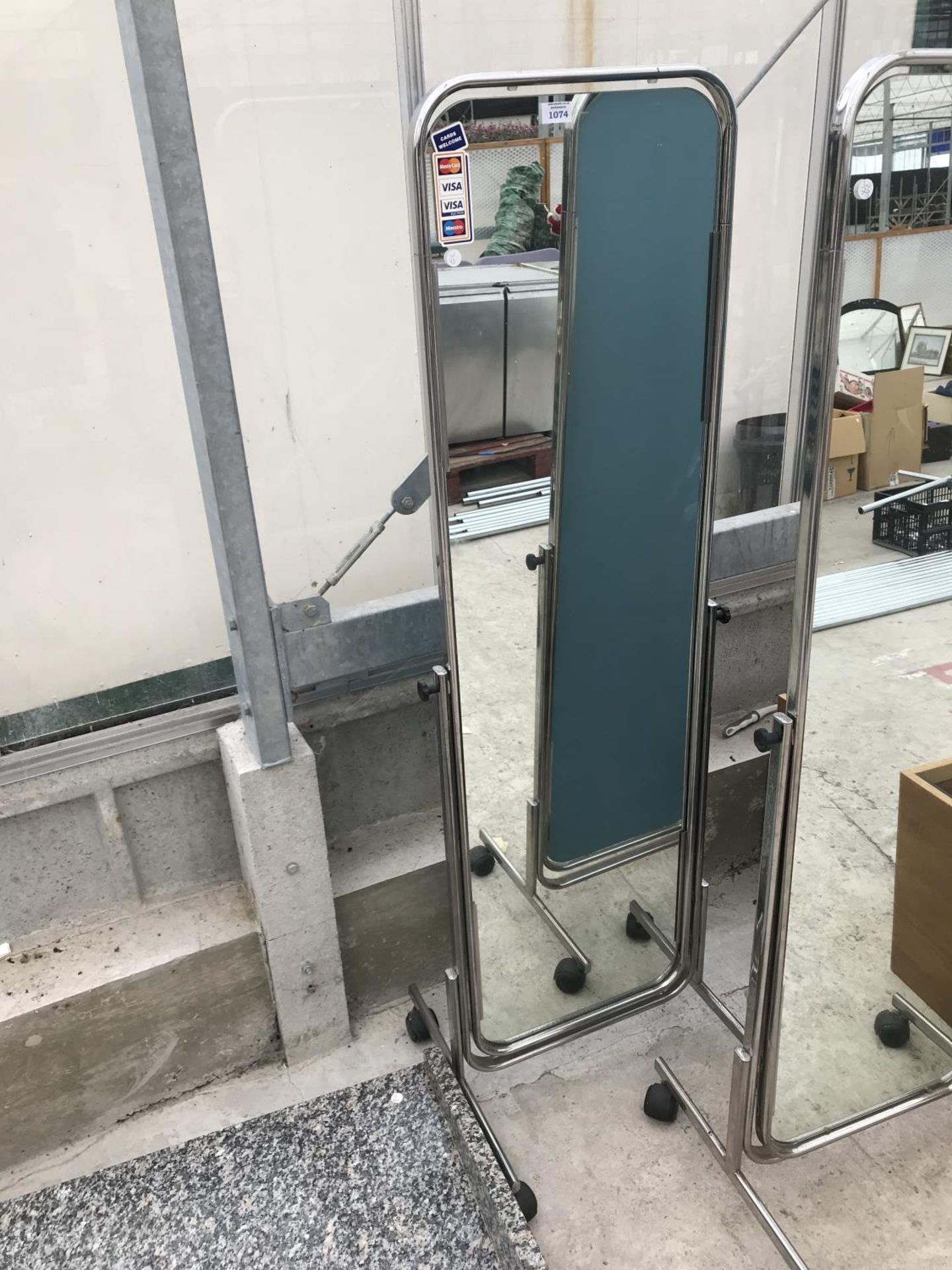 A FULL LENGTH SHOP MIRROR ON CASTERS