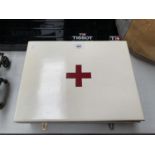 A WOODEN FIRST AID BOX