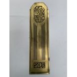 A BRASS ARTS AND CRAFTS STYLE FINGER PLATE