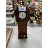 A MINIATURE POCKET WATCH HOLDER IN THE FORM OF A CLOCK