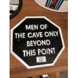 A CAST METAL 'MEN OF THE CAVE' SIGN