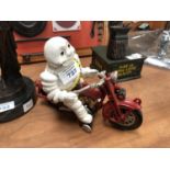 A CAST METAL MICHELIN MAN ON BIKE MODEL