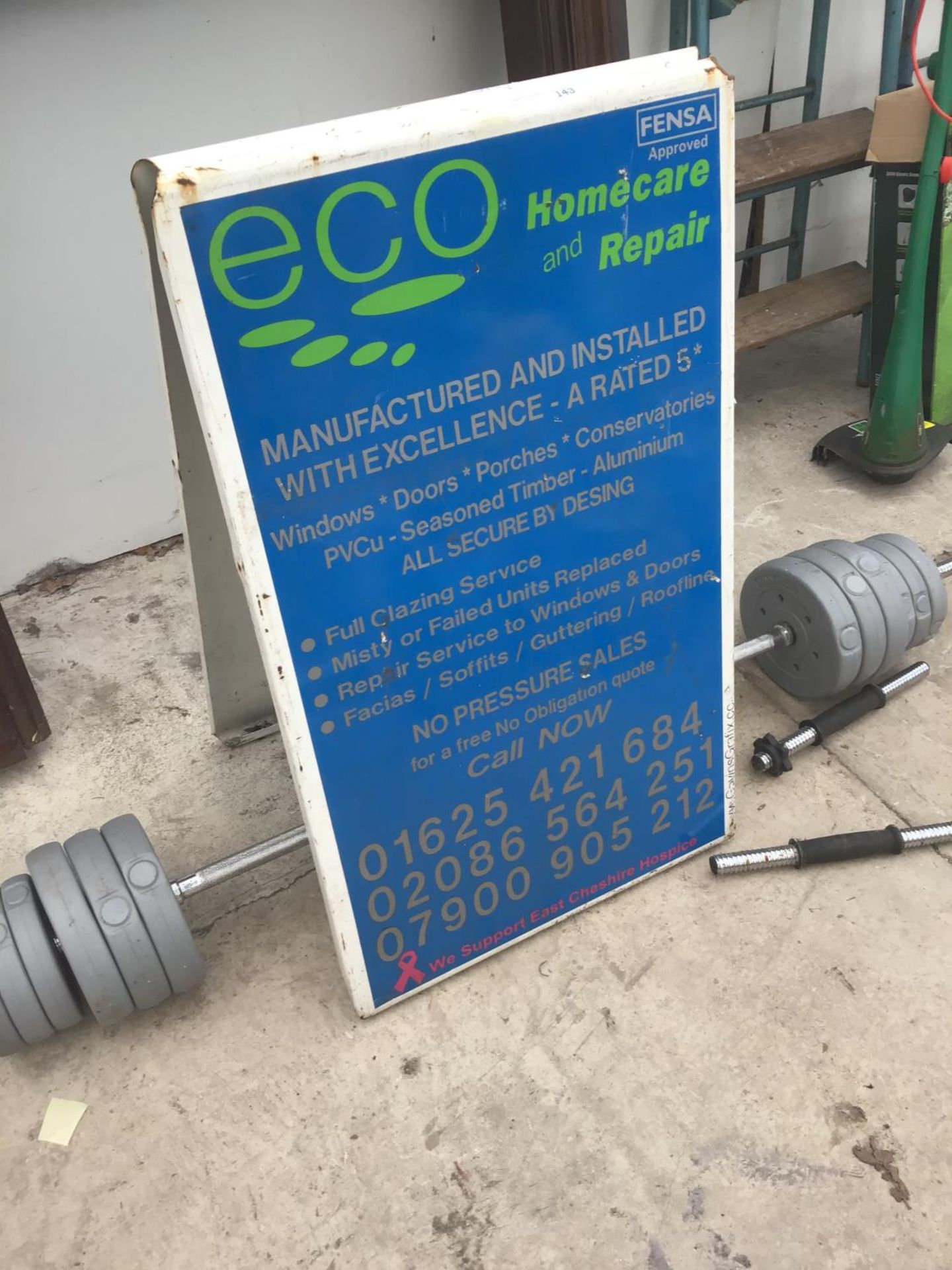 A METAL A FRAME ADVERTISING BOARDS AND A WEIGHT LIFTING BAR WITH WEIGHTS - Image 2 of 2