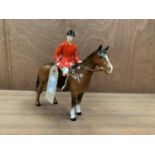 A BESWICK HUNSTMAN WITH RED JACKET ON HORSEBACK CERAMIC FIGURE