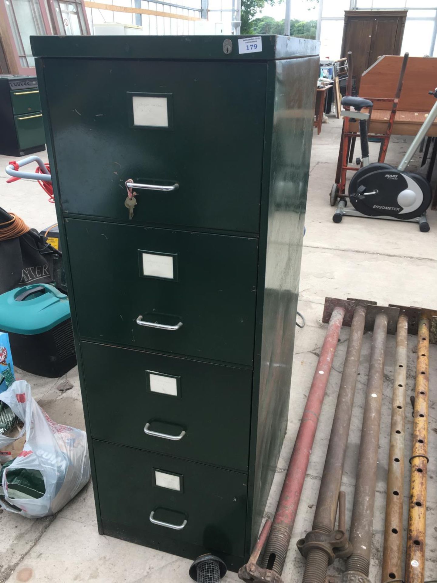 A VINTAGE GREEN FOUR DRAWER FILING CABINET WITH KEYS