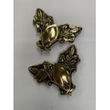 A PAIR OF BRASS FLORAL CORNERS