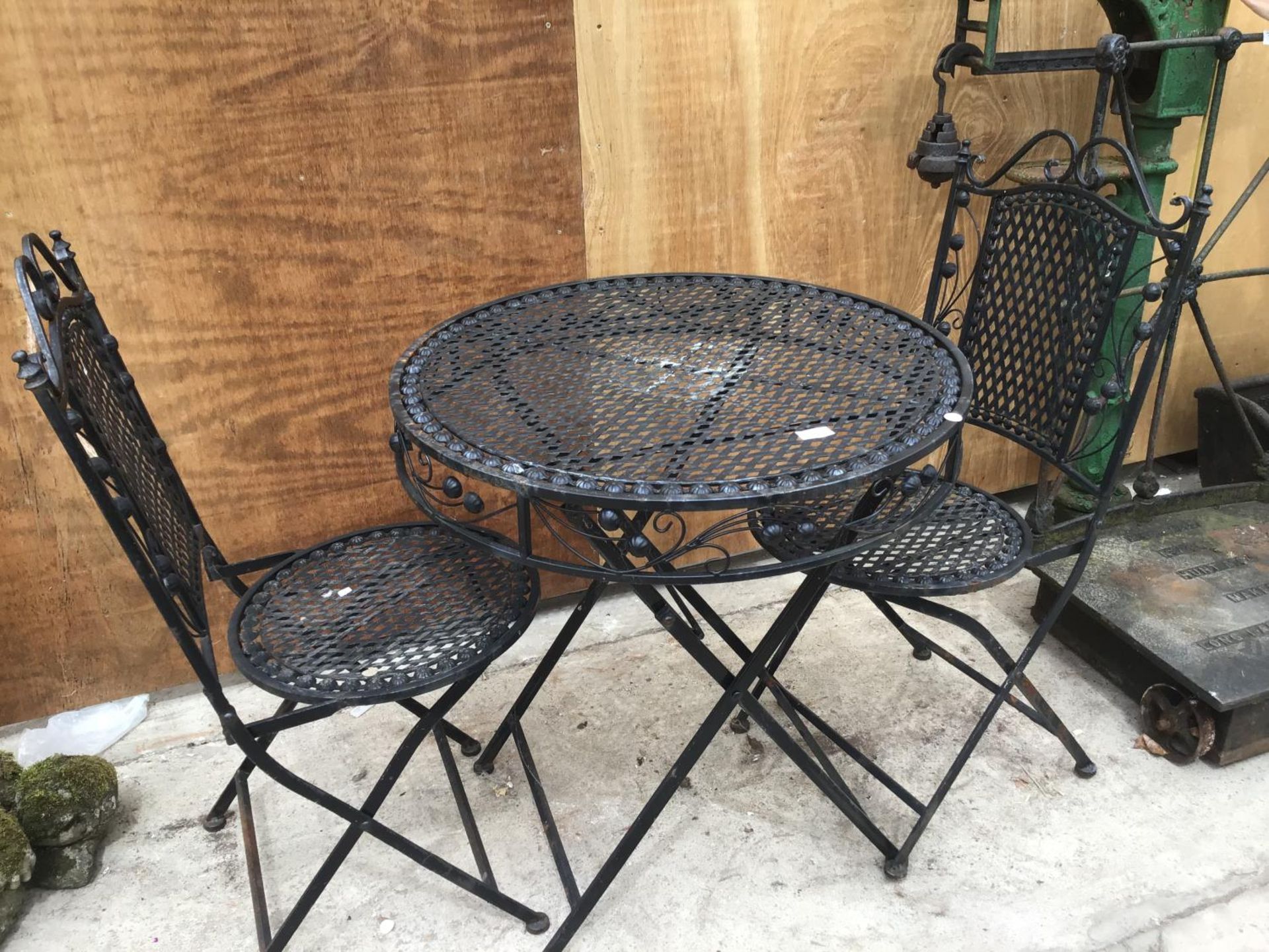 A FOLDING BISTRO TABLE WITH TWO MATCHING CHAIRS