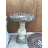 A CONCRETE BIRD BATH ON A TWIST SUPPORT 72 CM HIGH