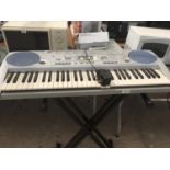 A YAMAHA KEYBOARD WITH STAND IN WORKING ORDER