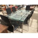 A GLASS TOPPED DINING TABLE AND SIX MODERN DINING CHAIRS