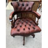 A RED LEATHER BUTTON BACK CHESTERFIELD CAPTAIN'S ARMCHAIR