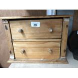 A PINE APPRENTICE STYLE CHEST OF DRAWERS