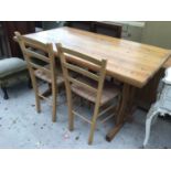 A MODERN PINE DINING TABLE AND TWO RUSH SEATED CHAIRS
