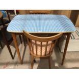 A RETRO FORMICA TOPPED KITCHEN TABLE AND TWO CHAIRS