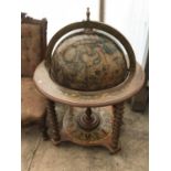 A DECORATIVE WOODEN ATLAS DRINKS GLOBE