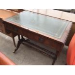 A MAHOGANY DROP END SOFA TABLE WITH BRASS FEET AND CASTERS AND GREEN LEATHER WRITING SURFACE