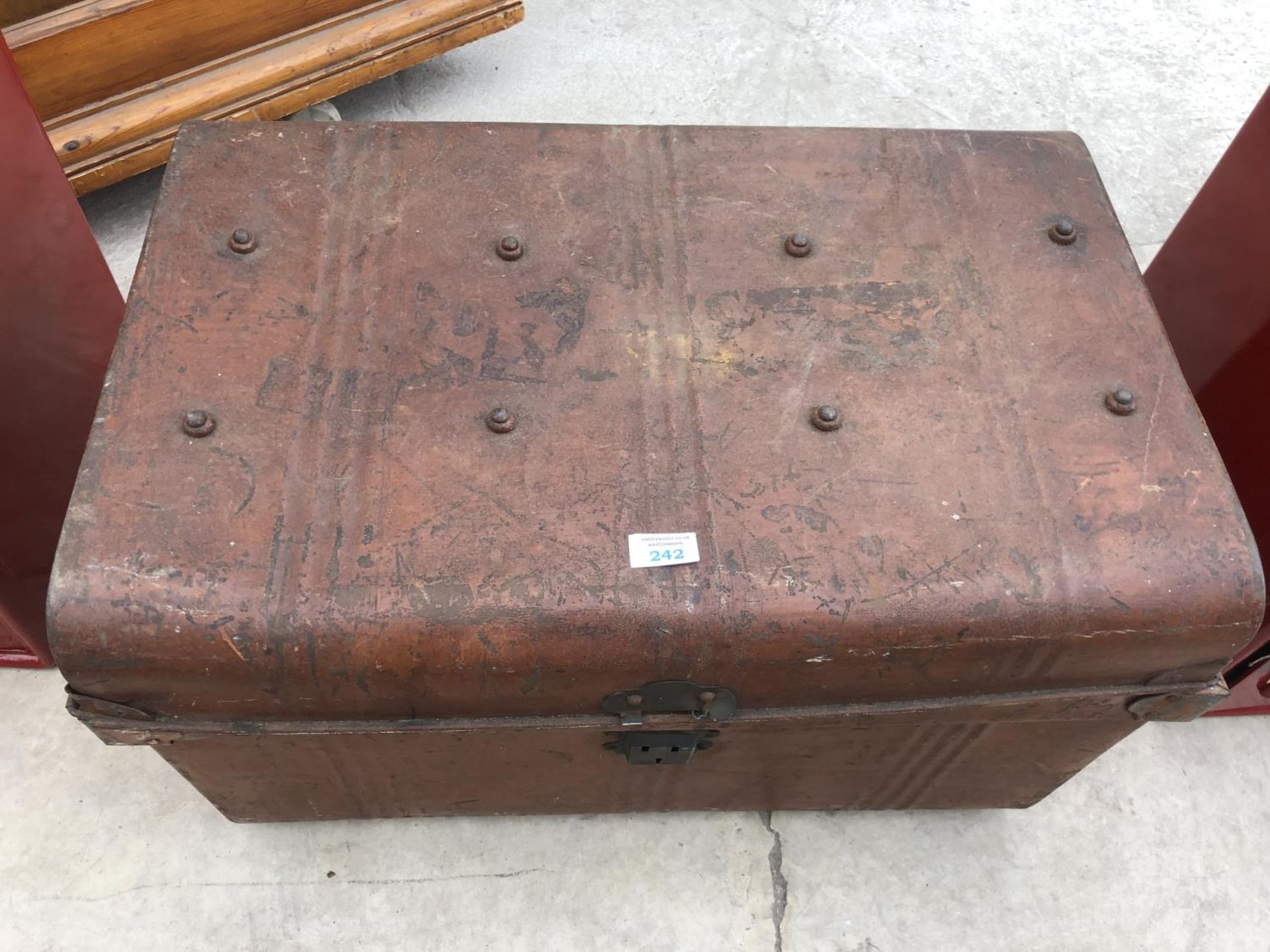 A VINTAGE METAL TRAVELLING TRUNK WITH BLUE INTERIOR