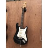 A BLACK ENCORE ELECTRIC GUITAR WITH WHAMMY BAR