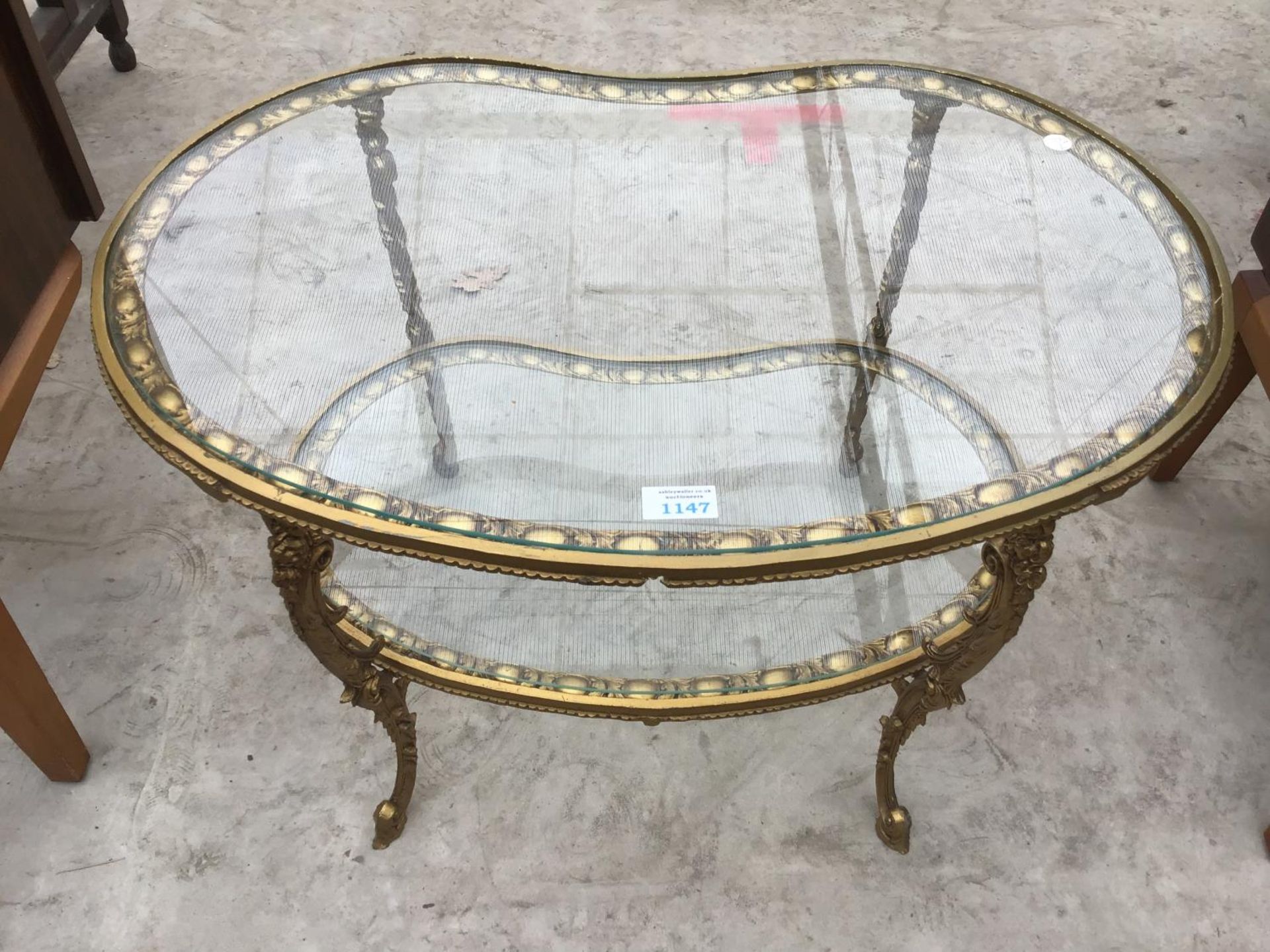 A DECORATIVE GILT AND GLASS COFFEE TABLE
